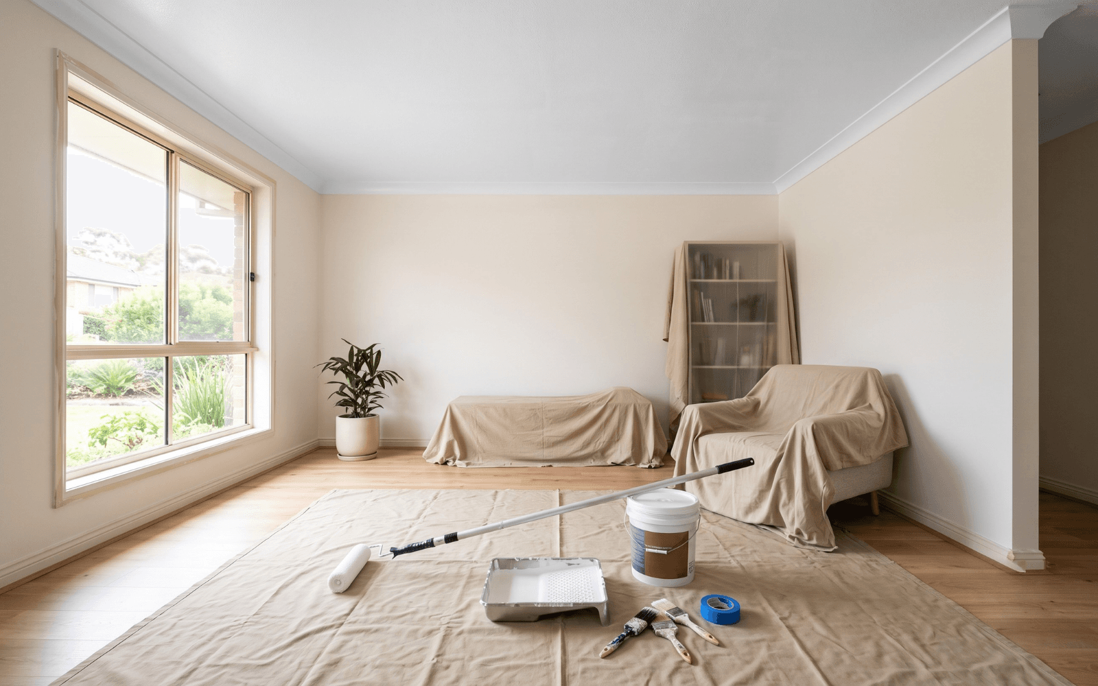 Interior painting preparation underway in a residential living room