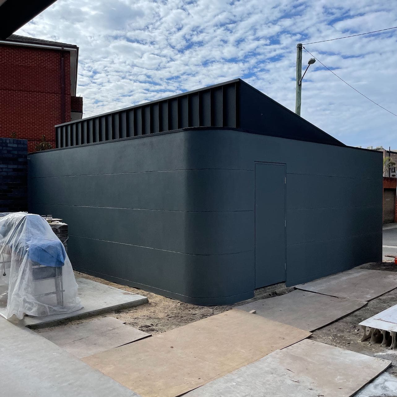 Rendered exterior wall painted charcoal on a Sydney home